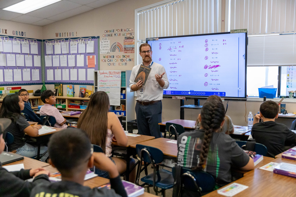 A man talking to a classroom full of students