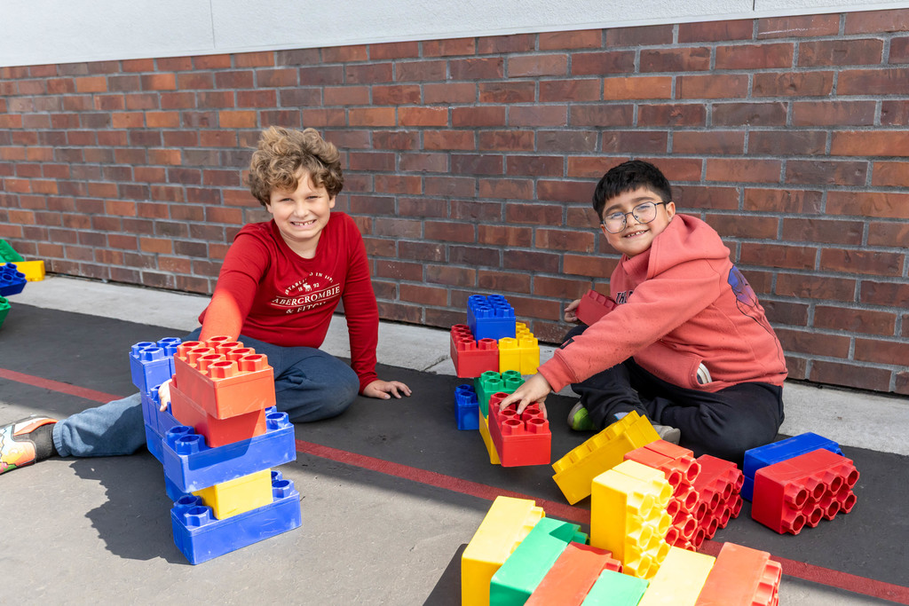 Students playing with large legos