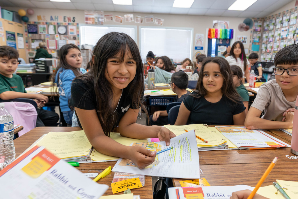 Student smiling while doing school work
