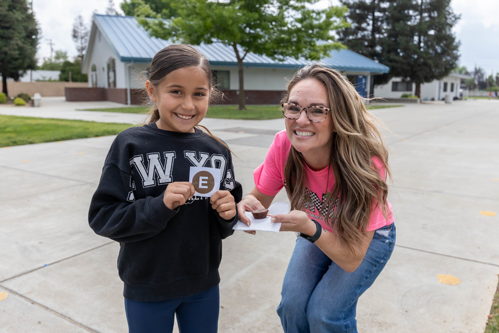 teacher and student holding brownies