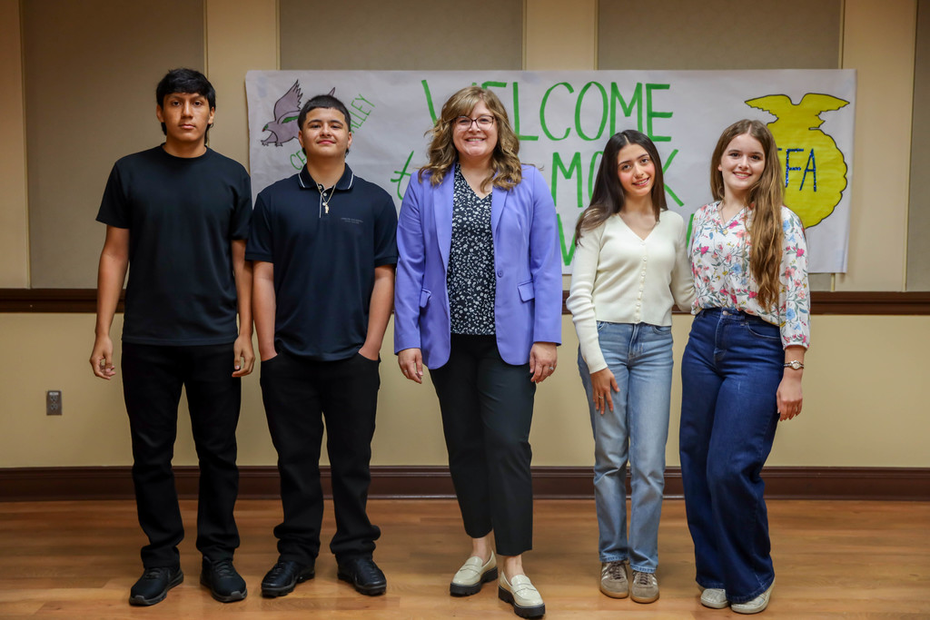 staff and students smiling for the camera