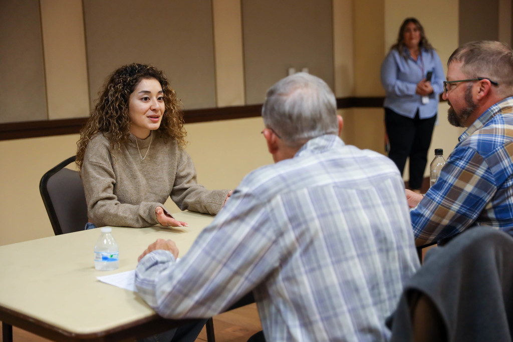 Student interviewing at a table
