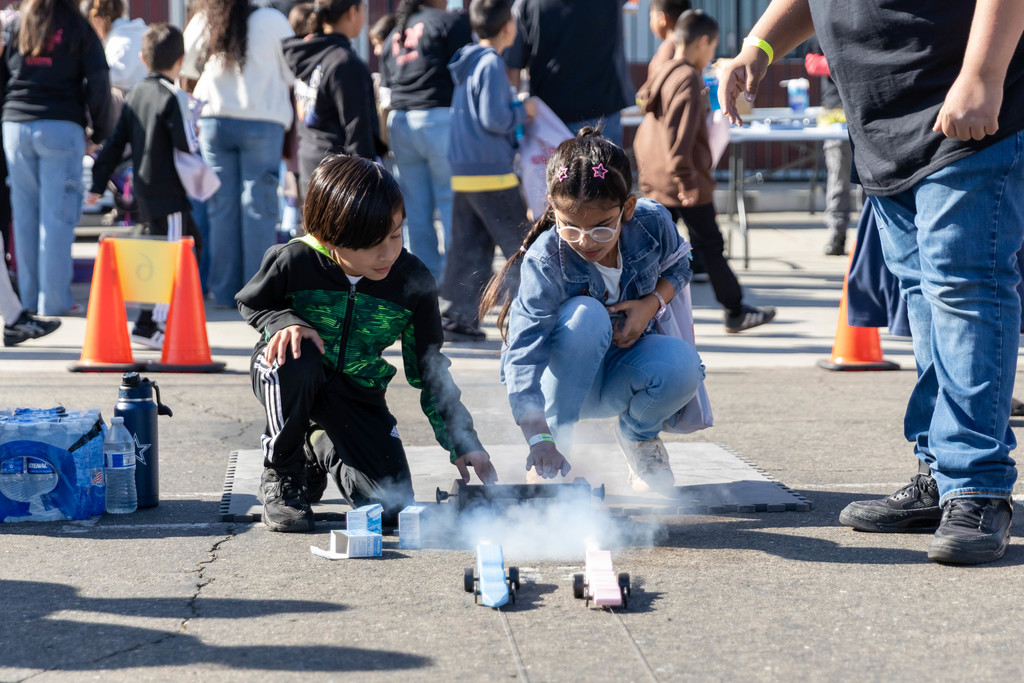 Students racing toy cars