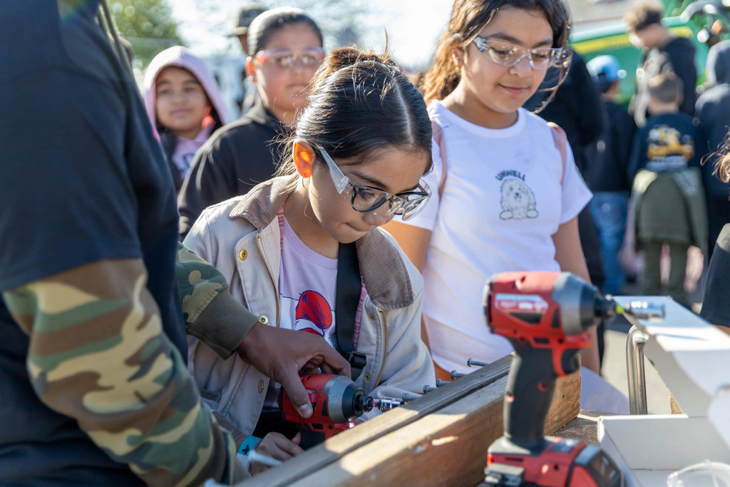 student with a drill