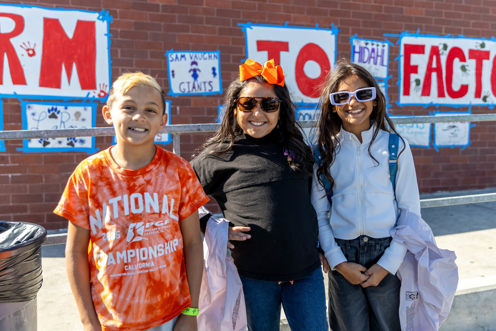 three students smiling