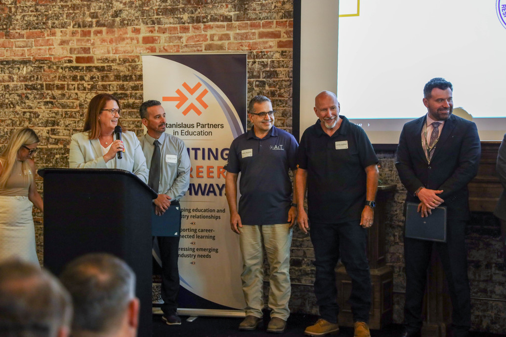 Staff and honorees on stage