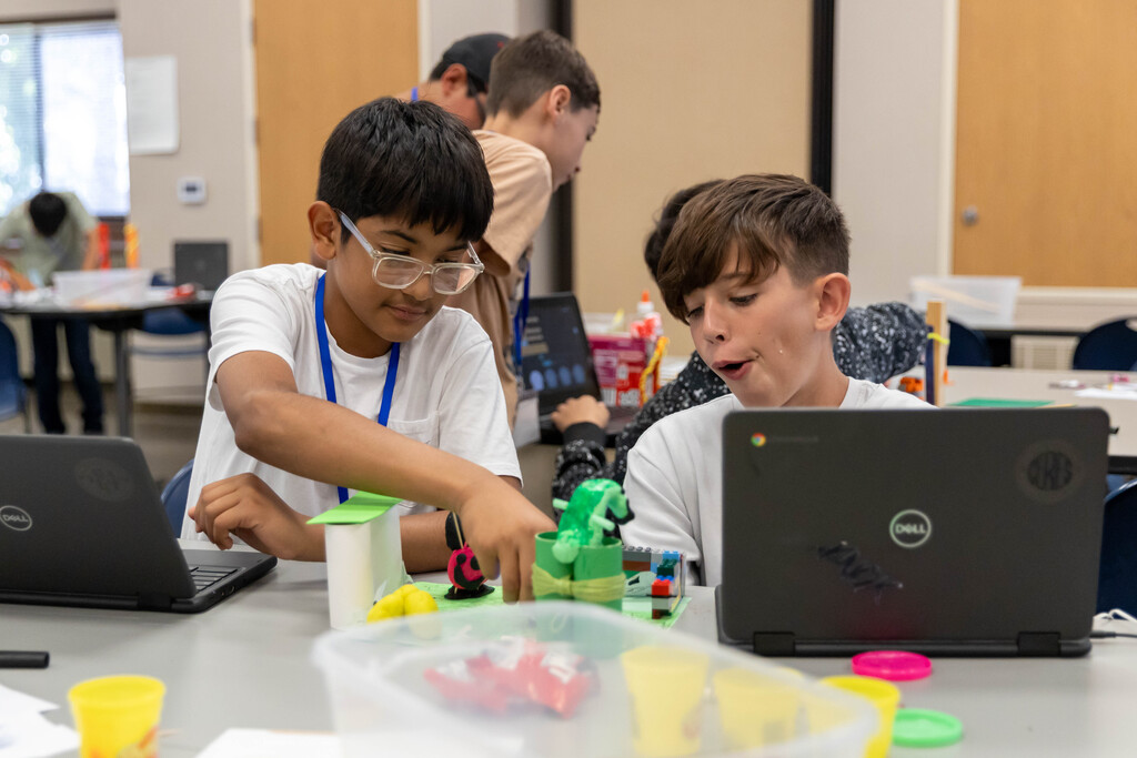 two students working with a robot