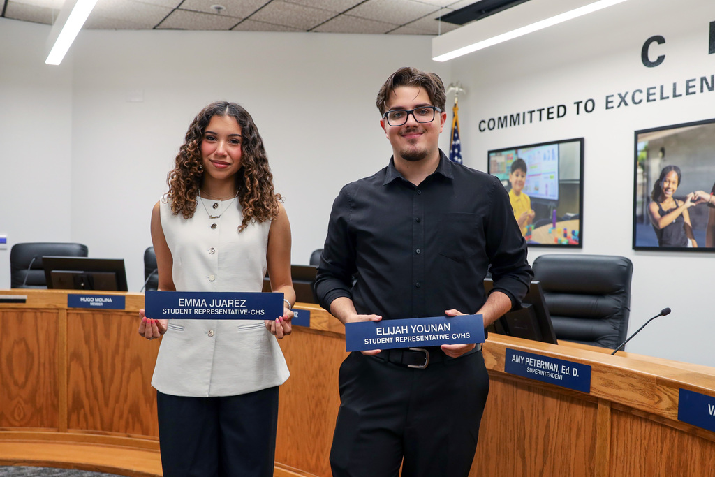 Student representatives hold their nameplates in Board Room
