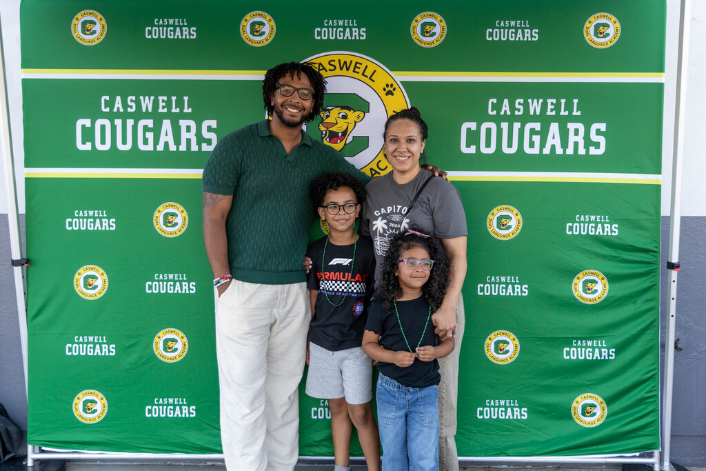 A family smiling at back to school night
