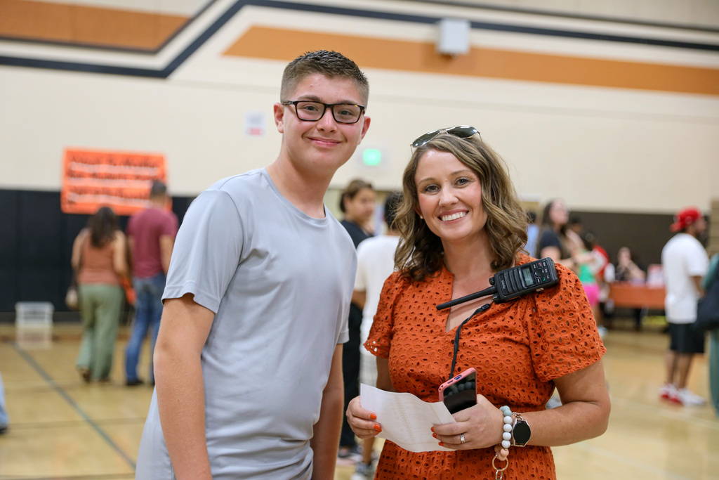 Staff and student smiling for a photo