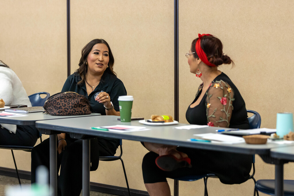 Two people talking at a table