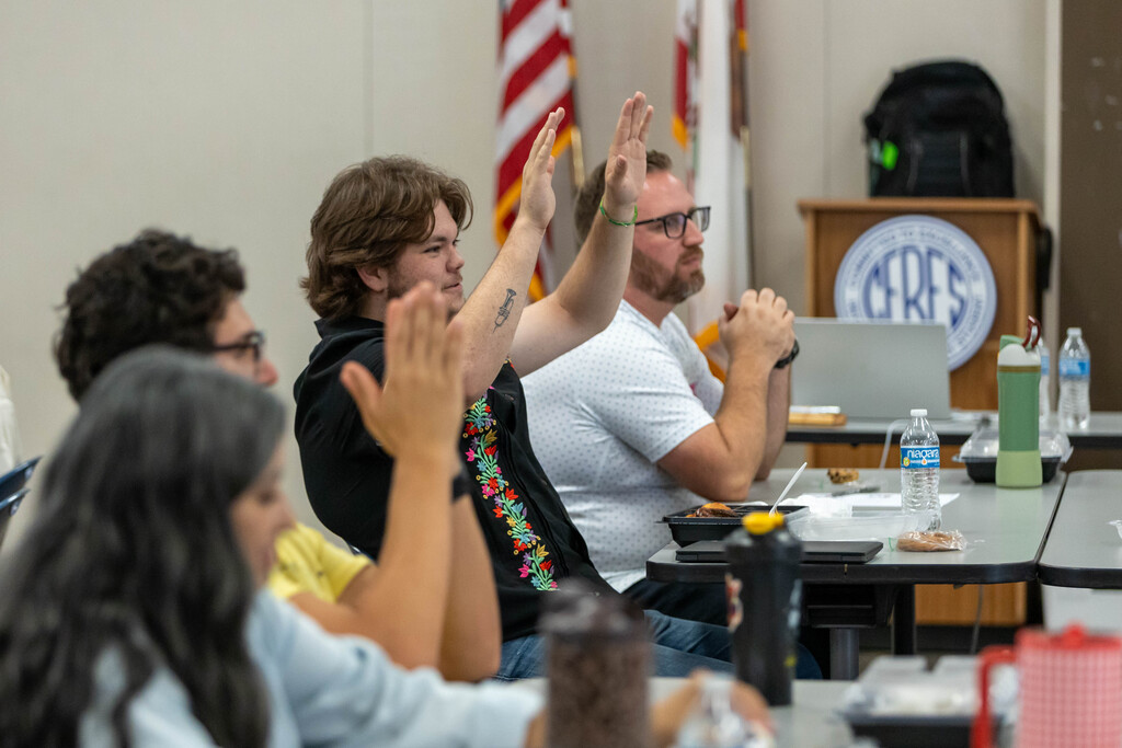 staff raising his hands