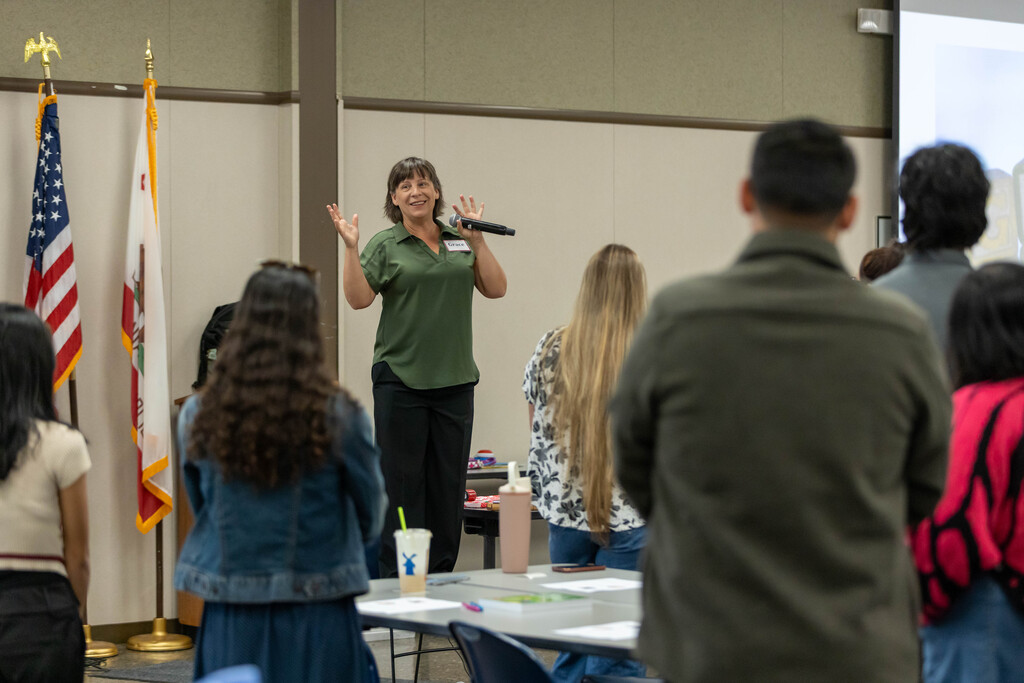 Grace talking to a large group of teachers