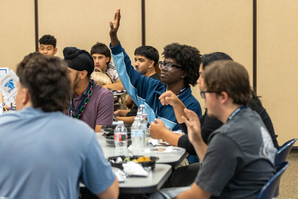 a student raising his hands