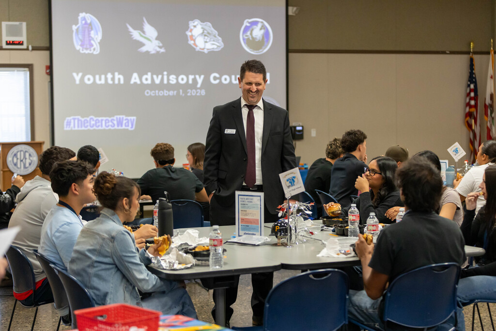 Staff talking to a table full of students