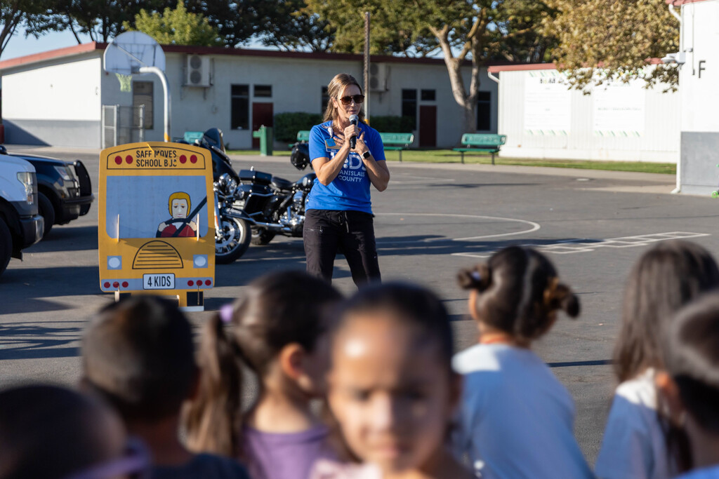 adult talking to a group of students