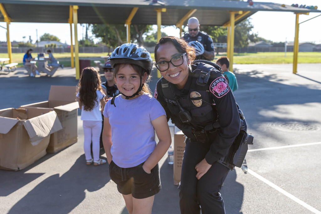 student and police officer smiling