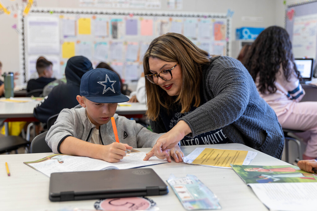 Staff helping a student with school work
