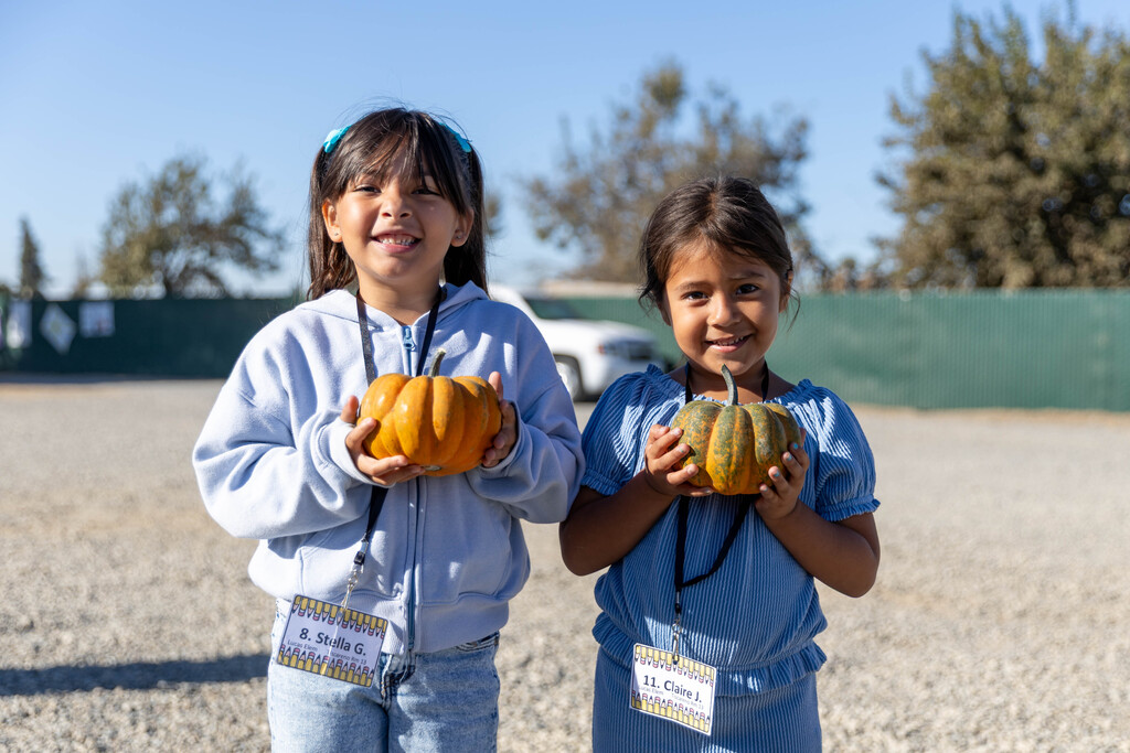 teo students holding pumpkins
