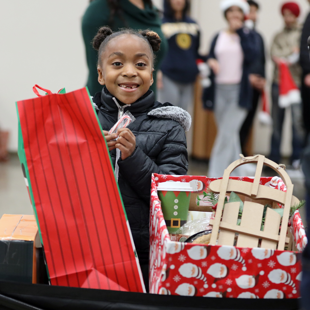 Smiling girl holds candy cane