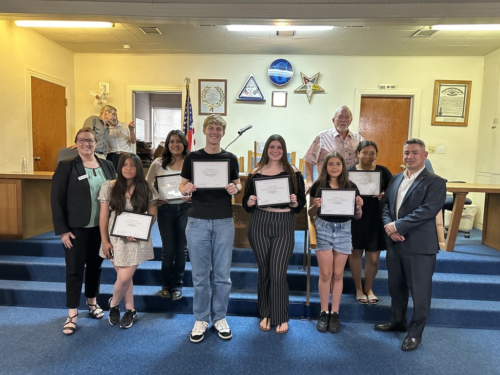 Winners holding certificates at Masonic Lodge