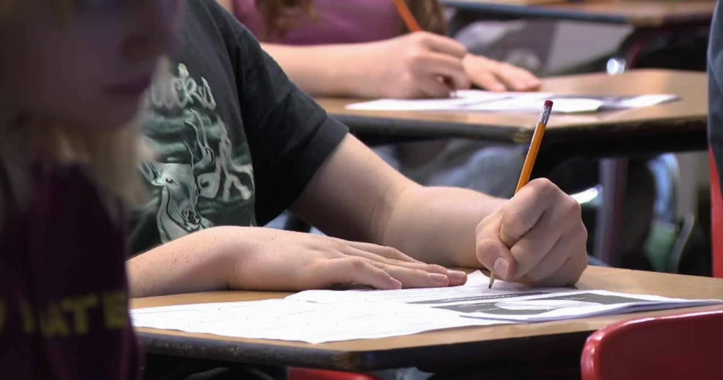 Student taking an exam at a desk