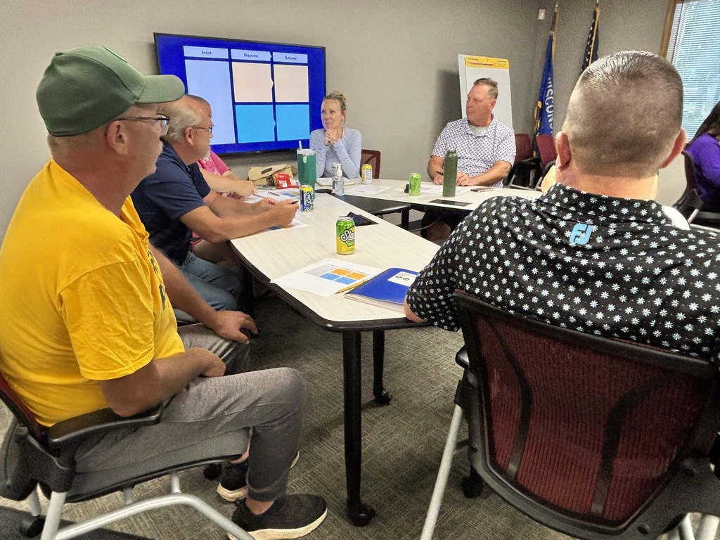 Group of coaches attending the Positive Impact Playbook workshop.
