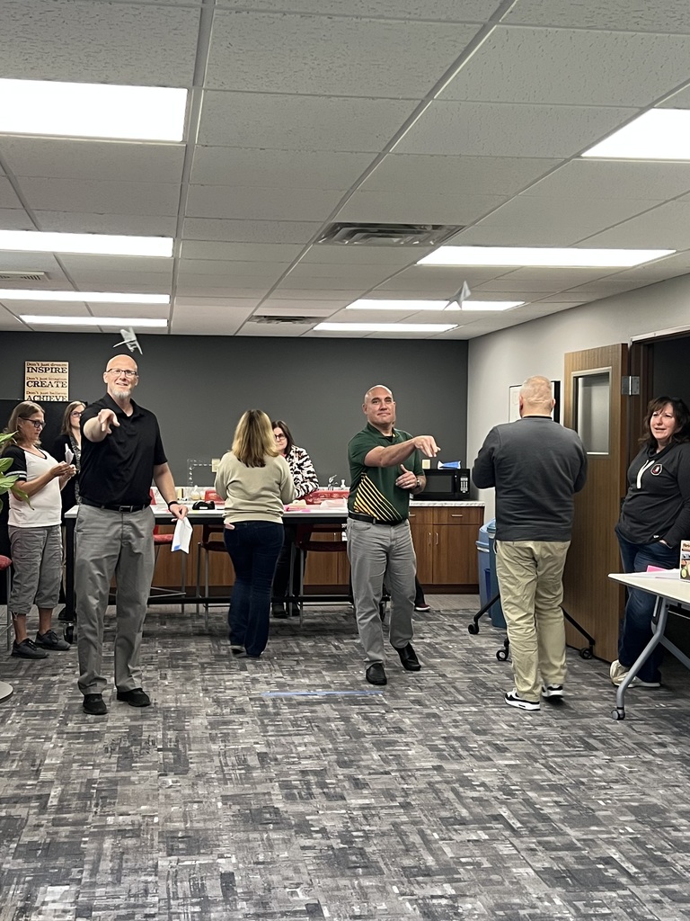 Staff throwing paper airplanes.