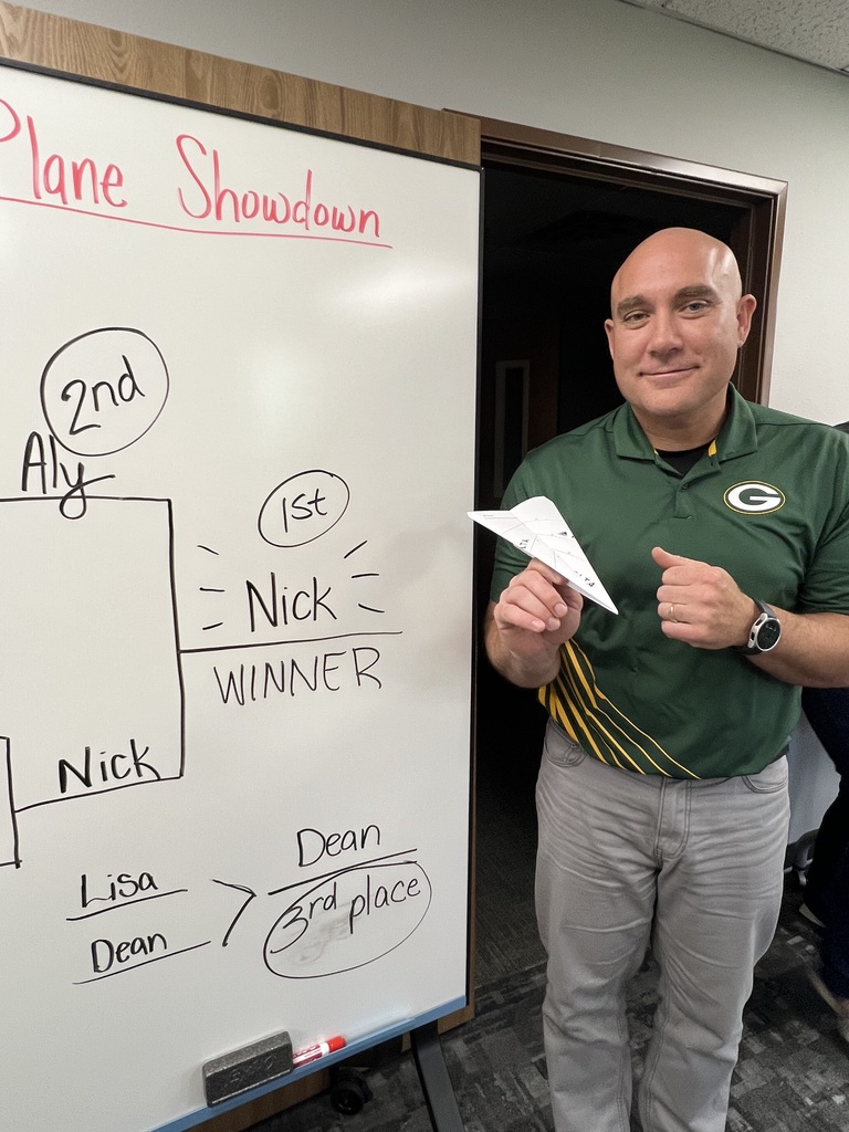 Nick Curran posing with a paper airplane.