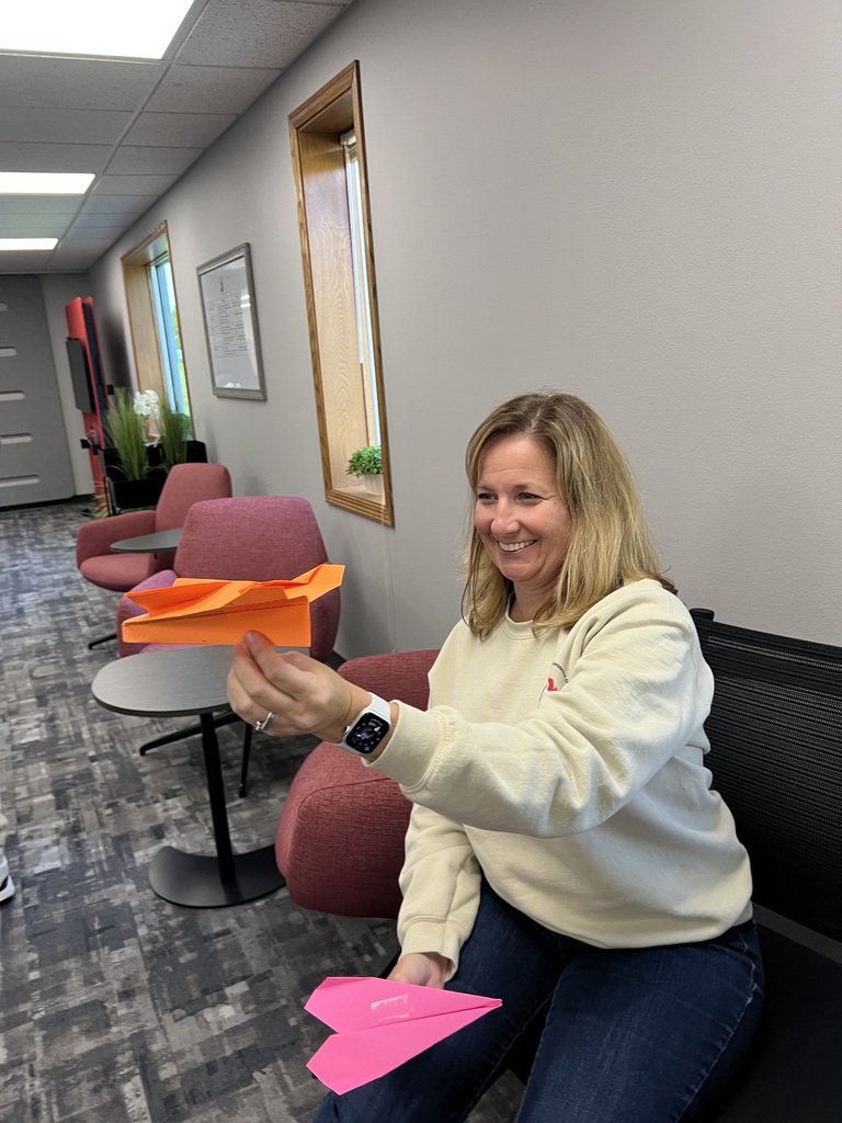 Staff making paper airplanes.