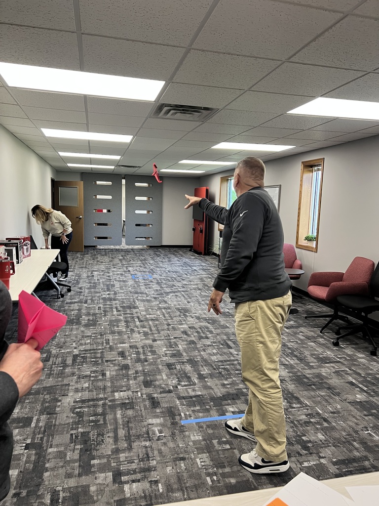 Staff throwing paper airplanes.