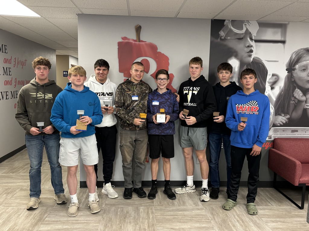 Students posing for a picture with their handmade project.