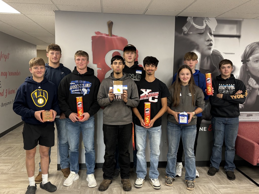Students posing for a picture with their handmade project.