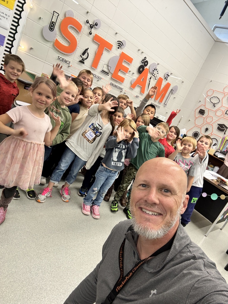 Elementary students posing for a selfie with Dean.