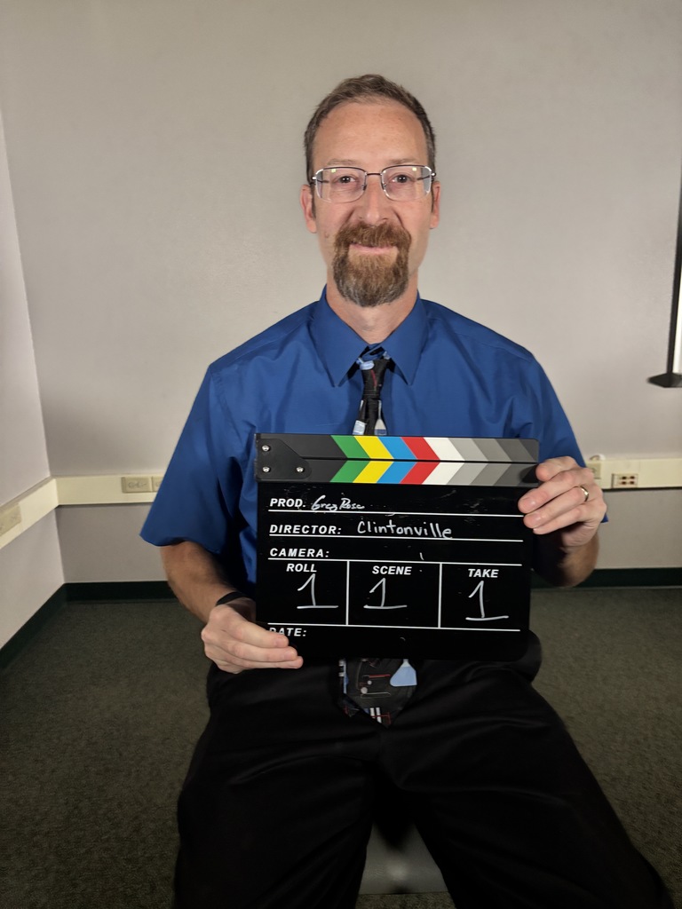 A person holding a clapper board.