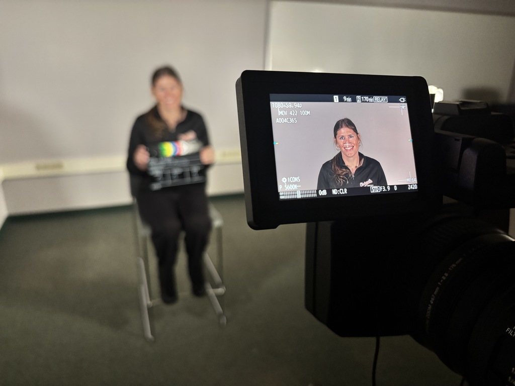 A person holding a clapper board.