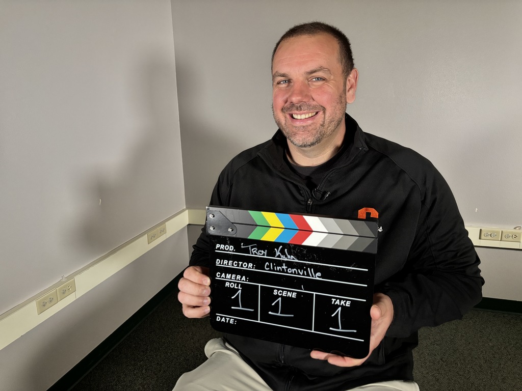 A person holding a clapper board.