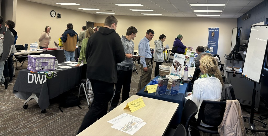 Students and exhibitors talk at a Transition Fair.