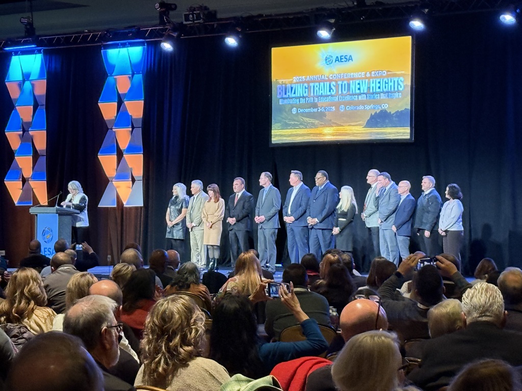 Dave Honish at AESA Convention staging on stage with board members.