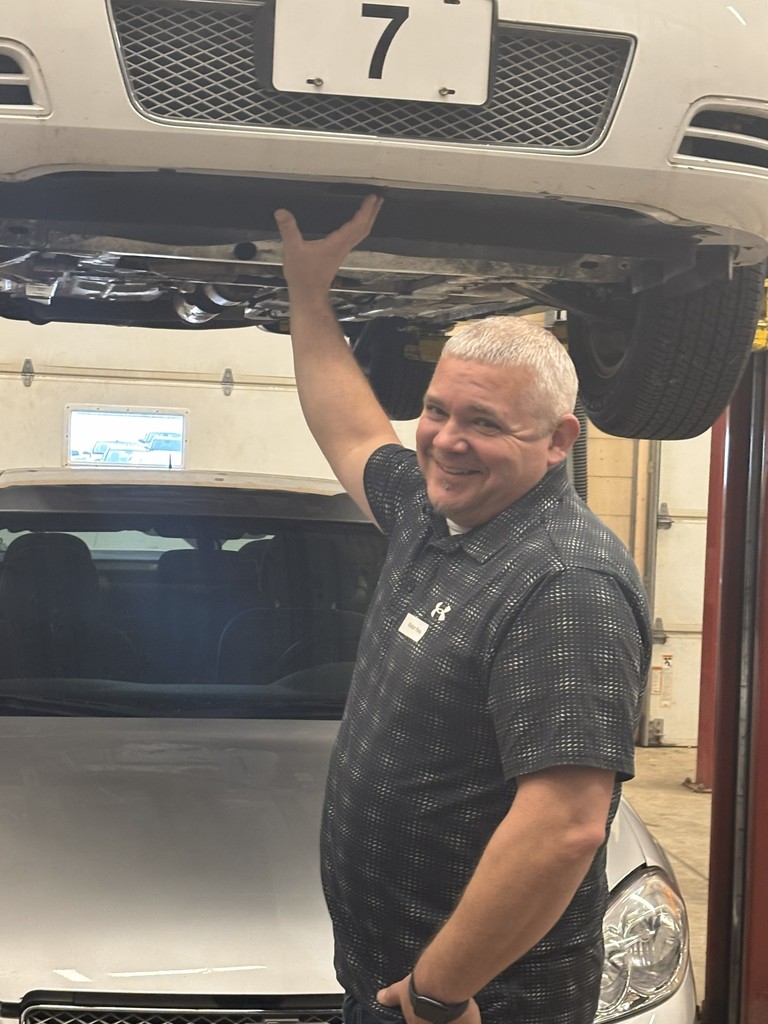 Technical education teacher working with a student.