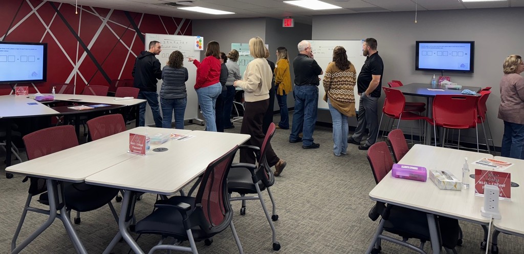 K–12 math educators, coaches, and leaders engaged in a mathematical modeling tasks.