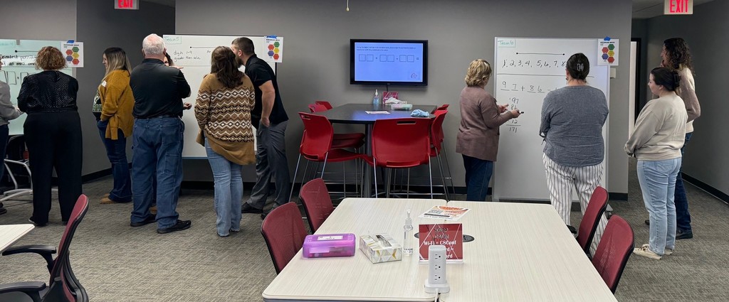 K–12 math educators, coaches, and leaders engaged in a mathematical modeling tasks.