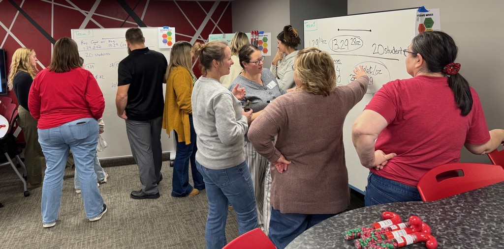 K–12 math educators, coaches, and leaders engaged in a mathematical modeling tasks.