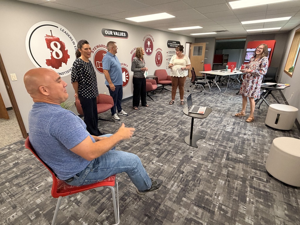 A small group of CESA 8 employees meeting.