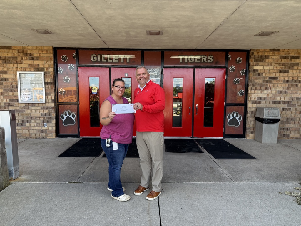 Dave Honish presenting a certificate to a Gillett School District employee.
