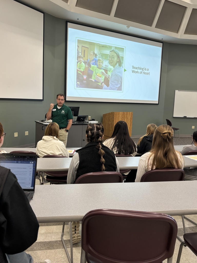 A presenter talks to a group at a recent education career event.