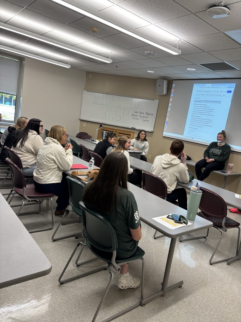 A presenter talks to a group at a recent education career event.