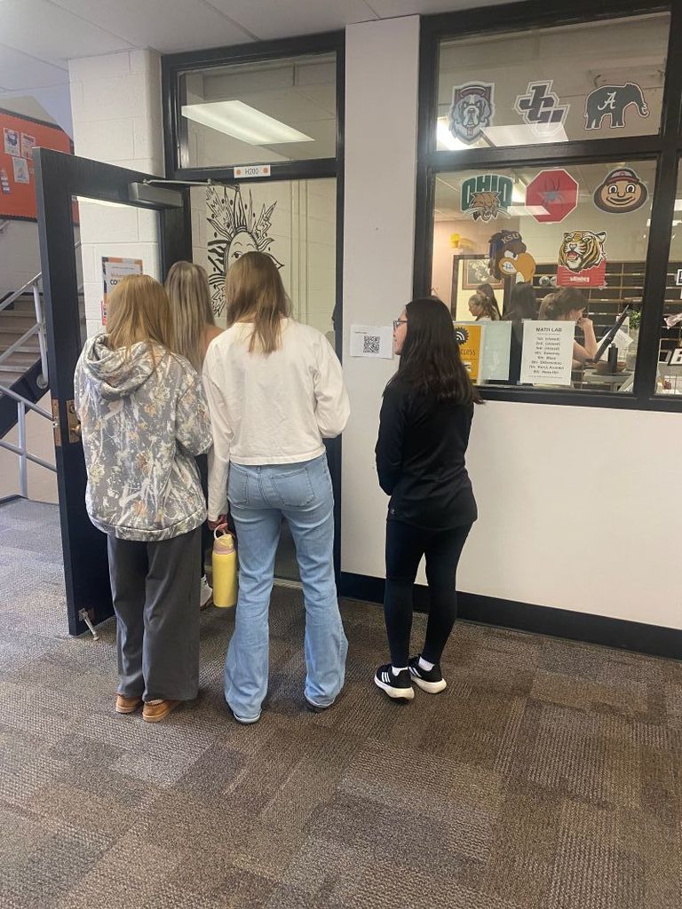 HS Health Students reviewing mental health materials during a qr code scavenger hunt.
