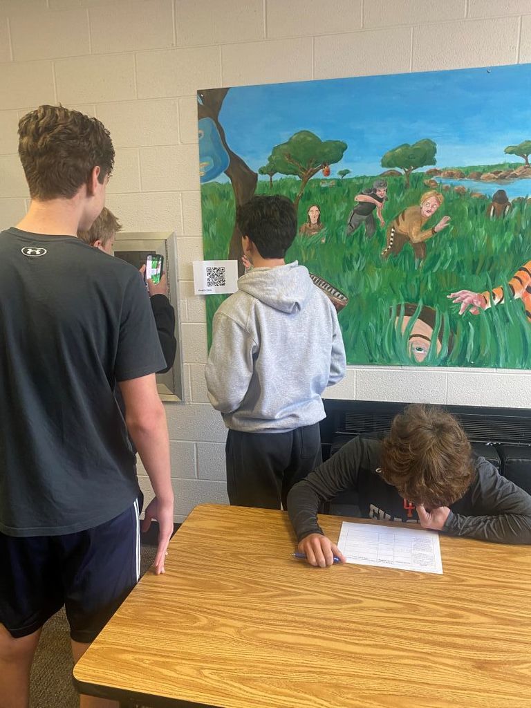 HS Health Students reviewing mental health materials during a qr code scavenger hunt.