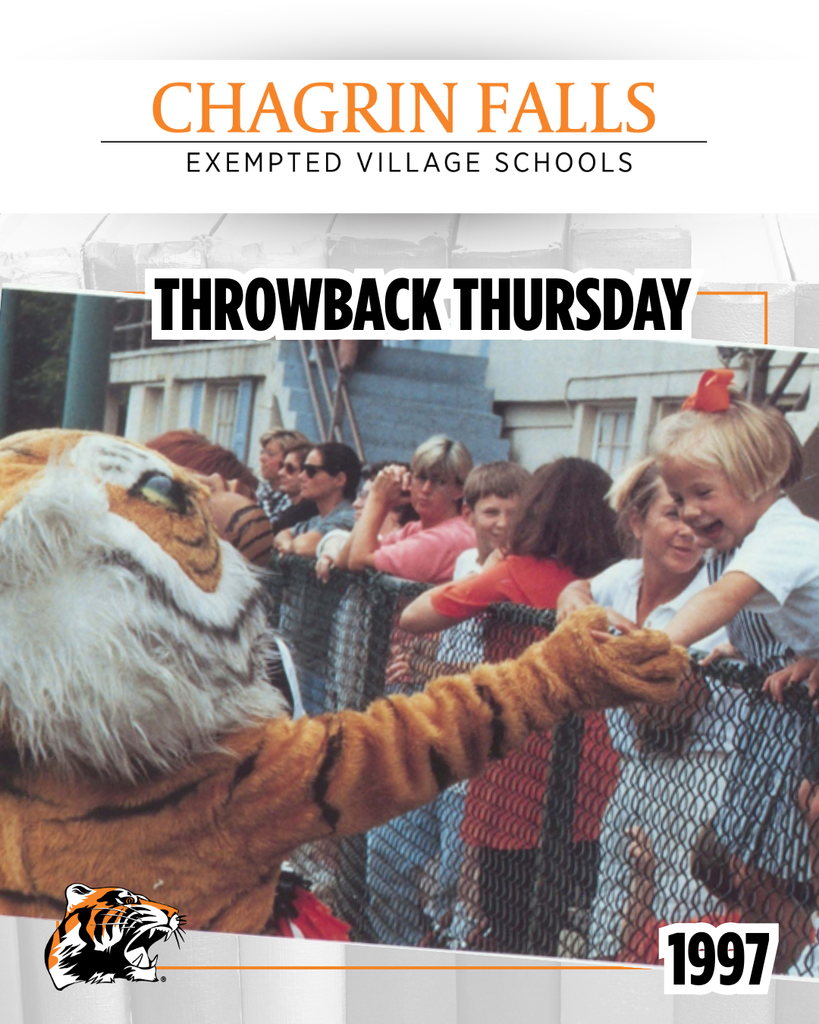 A 1997 photo of Mortimer the Tiger mascot giving a high five to a young girl reaching over the fence at Harris Field, while fans look on in the background.